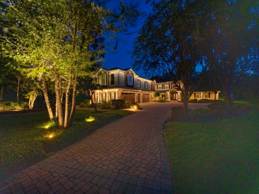 A house with trees and lawns at night